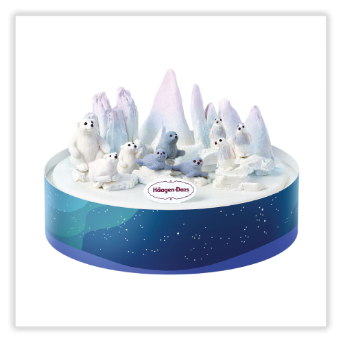 A cake decorated in Arctic Paradise theme topped with 3D chocolate polar bears, penguins and seals